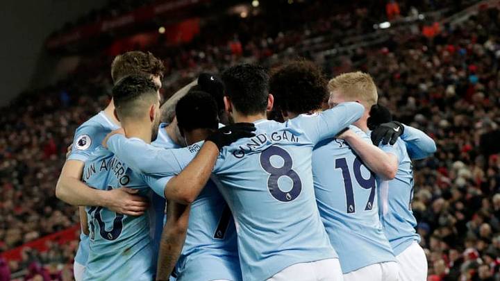 LIVERPOOL, ENGLAND - JANUARY 14: Leroy Sane of Manchester City celebrates with team mates after scoring the first Manchester City goal during the Premier League match between Liverpool and Manchester City at Anfield on January 14, 2018 in Liverpool, England. (Photo by Victoria Haydn/Man City via Getty Images)