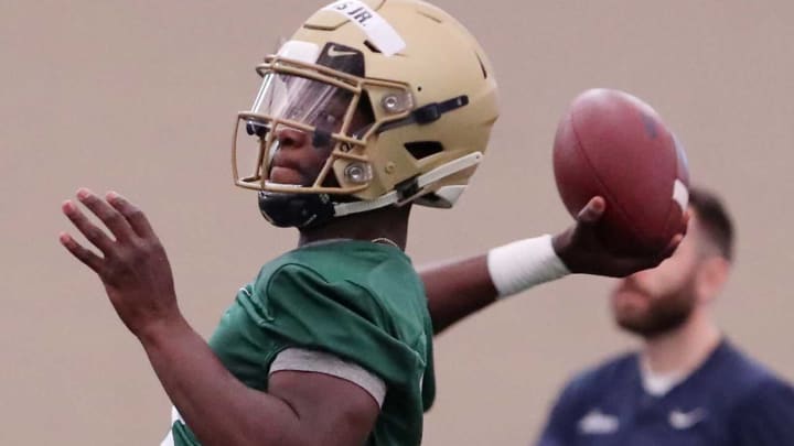 Quarterback DJ Irons throws during the first spring football practice of the University of Akron football team at Stile Athletics Field House on the campus Tuesday morning.Akr329uafootball06