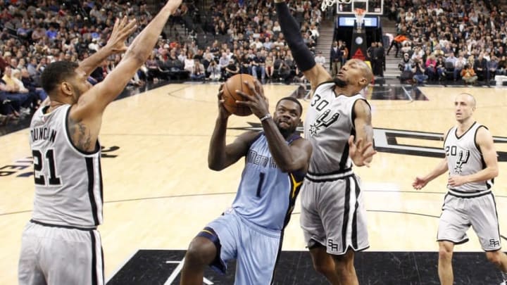 Mar 25, 2016; San Antonio, TX, USA; Memphis Grizzlies small forward Lance Stephenson (1) drives to the basket as San Antonio Spurs power forward Tim Duncan (21) and David West (30) defend during the first half at AT&T Center. Mandatory Credit: Soobum Im-USA TODAY Sports