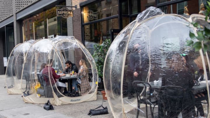 NEW YORK, NEW YORK - OCTOBER 25: People dine outdoors in plastic bubbles at Suprema Provisions on October 25, 2020 in New York City. Restaurants are finding ways to extend the outdoor dining season as long as possible by adding plastic bubbles, outdoor heaters and plexiglass tents. The pandemic continues to burden restaurants and bars as businesses struggle to thrive with evolving government restrictions and social distancing plans which impact keeping businesses open yet challenge profitability. (Photo by Alexi Rosenfeld/Getty Images)