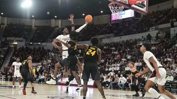 Feb 4, 2023; Starkville, Mississippi, USA; Mississippi State Bulldogs guard Cameron Matthews (4) goes up for a shot while defended by Missouri Tigers guard Sean East II (55) at Humphrey Coliseum. Mandatory Credit: Matt Bush-USA TODAY Sports