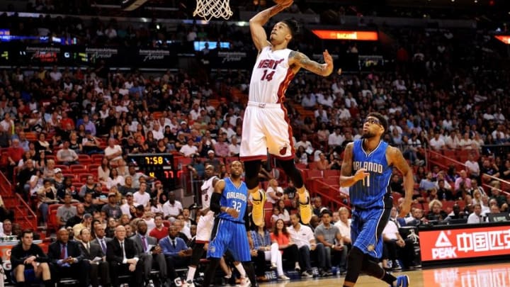 Apr 10, 2016; Miami, FL, USA; Miami Heat forward Gerald Green (14) dunks the ball as Orlando Magic forward Devyn Marble (11) looks on during the second half at American Airlines Arena. The Heat won 118-96. Mandatory Credit: Steve Mitchell-USA TODAY Sports