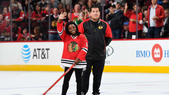 CHICAGO, IL - OCTOBER 12: Olympic gold medalist Simone Biles shoots the puck in between periods of the game between the Chicago Blackhawks and the St. Louis Blues during the season opener at the United Center on October 12, 2016 in Chicago, Illinois. (Photo by Bill Smith/NHLI via Getty Images)