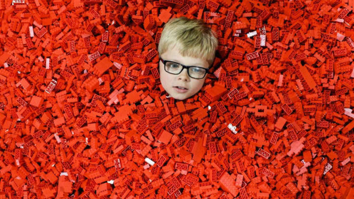 GLASGOW, SCOTLAND - JULY 20: Seven year old Ben MacDonald, submerses himself in Lego during Bricklive at the Scottish Exhibition and Conference Center on July 20, 2017 in Glasgow, Scotland. Europe's largest Lego event was debuting in the city for the first time, treating fans to creations from the world's best builders. (Photo by Jeff J Mitchell/Getty Images)