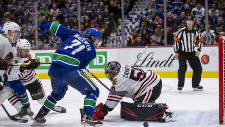 VANCOUVER, BC - FEBRUARY 20: Zack MacEwen #71 of the Vancouver Canucks is stopped by goaltender Corey Crawford #50 of the Chicago Blackhawks during the second period at Rogers Arena on February 12, 2020 in Vancouver, Canada. (Photo by Ben Nelms/Getty Images)