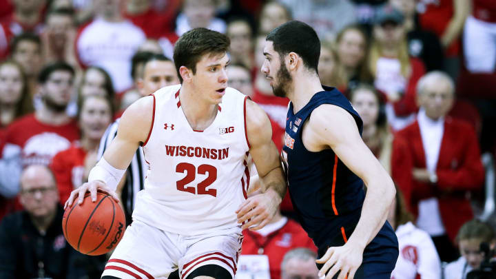 MADISON, WISCONSIN – FEBRUARY 18: Ethan Happ #22 of the Wisconsin Badgers dribbles the ball while being guarded by Giorgi Bezhanishvili #15 of the Illinois Fighting Illini in the first half at the Kohl Center on February 18, 2019 in Madison, Wisconsin. (Photo by Dylan Buell/Getty Images)
