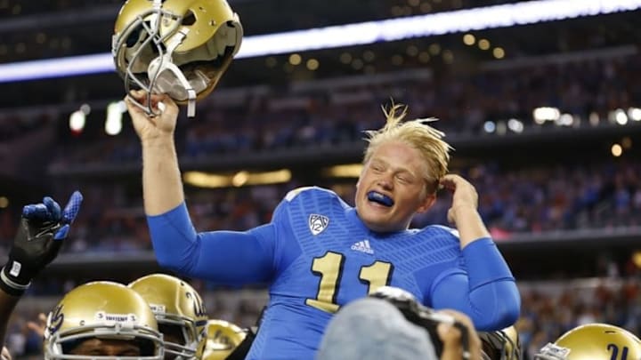 Sep 13, 2014; Arlington, TX, USA; UCLA Bruins quarterback Jerry Neuheisel (11) celebrates on top of his teammates shoulders after a victory against the Texas Longhorns at AT&T Stadium. The Bruins beat the Longhorns 20-17. Mandatory Credit: Matthew Emmons-USA TODAY Sports Sep 13, 2014; Arlington, TX, USA; UCLA Bruins quarterback Jerry Neuheisel (11) celebrates on top of his teammates shoulders after a victory against the Texas Longhorns at AT&T Stadium. The Bruins beat the Longhorns 20-17. Mandatory Credit: Matthew Emmons-USA TODAY Sports