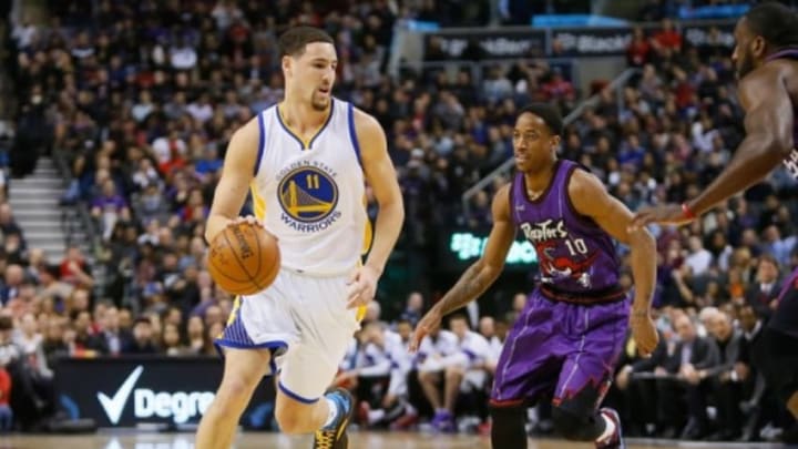 Feb 27, 2015; Toronto, Ontario, CAN; Golden State Warriors guard Klay Thompson (11) drives to the basket past Toronto Raptors guard DeMar DeRozan (10) during the first half at the Air Canada Centre. Mandatory Credit: John E. Sokolowski-USA TODAY Sports