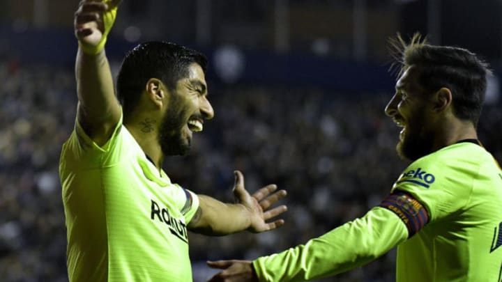 Barcelona's Uruguayan forward Luis Suarez (L) celebrates a goal with Barcelona's Argentinian forward Lionel Messi during the Spanish League football match between Levante and Barcelona at the Ciutat de Valencia stadium in Valencia on December 16, 2018. (Photo by JOSE JORDAN / AFP) (Photo credit should read JOSE JORDAN/AFP/Getty Images)