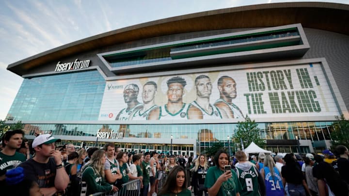 MILWAUKEE, WISCONSIN - JULY 01: Basketball fans arrive before Game Five of the Eastern Conference Finals between the Milwaukee Bucks and the Atlanta Hawks at Fiserv Forum on July 01, 2021 in Milwaukee, Wisconsin. NOTE TO USER: User expressly acknowledges and agrees that, by downloading and or using this photograph, User is consenting to the terms and conditions of the Getty Images License Agreement. (Photo by Patrick McDermott/Getty Images) MILWAUKEE, WISCONSIN - JULY 01: Basketball fans arrive before Game Five of the Eastern Conference Finals between the Milwaukee Bucks and the Atlanta Hawks at Fiserv Forum on July 01, 2021 in Milwaukee, Wisconsin. NOTE TO USER: User expressly acknowledges and agrees that, by downloading and or using this photograph, User is consenting to the terms and conditions of the Getty Images License Agreement. (Photo by Patrick McDermott/Getty Images)