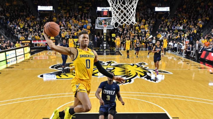 WICHITA, KS - NOVEMBER 23: Dexter Dennis #0 of the Wichita State Shockers drives to the basket for a dunk past Max Abmas #3 of the Oral Roberts Golden Eagles during the second half on November 23, 2019 at Charles Koch Arena in Wichita, Kansas. (Photo by Peter G. Aiken/Getty Images)
