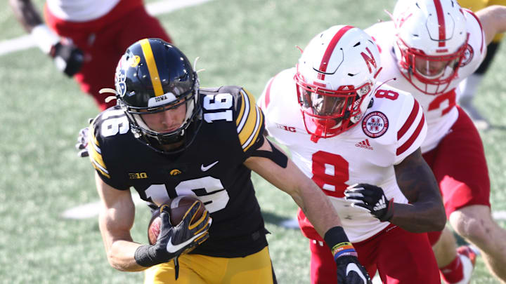 IOWA CITY, IOWA- NOVEMBER 27: Wide receiver Charlie Jones #16 of the Iowa Hawkeyes runs up the field during a punt return in the first half in front of safety Deontai Williams #8 of the Nebraska Cornhuskers at Kinnick Stadium on November 27, 2020 in Iowa City, Iowa. (Photo by Matthew Holst/Getty Images)