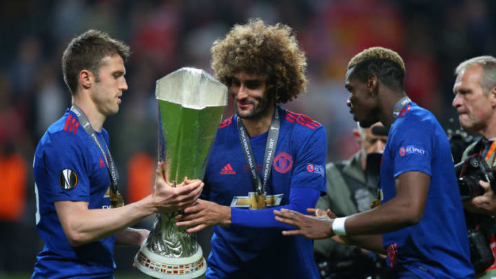 STOCKHOLM, SWEDEN - MAY 24: Michael Carrick, Marouane Fellaini and Paul Pogba of Manchester United with the trophy during the UEFA Europa League Final match between Ajax and Manchester United at Friends Arena on May 24, 2017 in Stockholm, Sweden. (Photo by Catherine Ivill - AMA/Getty Images)