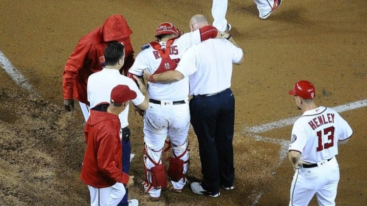 Sep 26, 2016; Washington, DC, USA; Washington Nationals catcher Wilson Ramos (40) is helped off the field by team trainer Paul Lessard after suffering an apparent right knee injury against the Arizona Diamondbacks during the sixth inning at Nationals Park. Mandatory Credit: Brad Mills-USA TODAY Sports