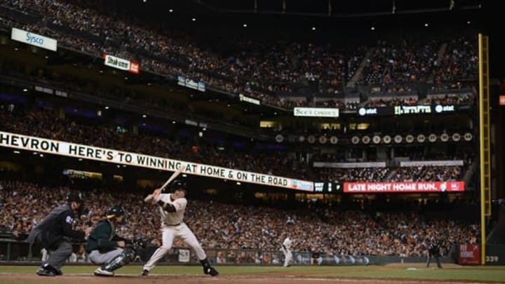 May 29, 2013; San Francisco, CA, USA; San Francisco Giants catcher Buster Posey (28, right) at bat in front of umpire Brian Knight (91) and Oakland Athletics catcher John Jaso (5, center) during the fifth inning at AT