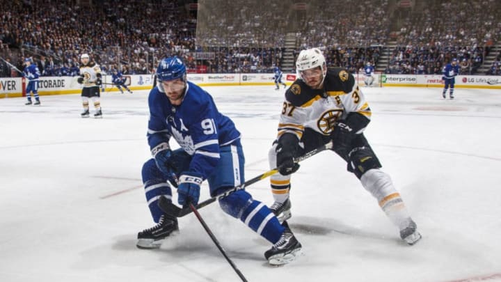 TORONTO, ON - APRIL 15: John Tavares #91 of the Toronto Maple Leafs battles for the puck against Patrice Bergeron #37 of the Boston Bruins during the first period in Game Three of the Eastern Conference First Round during the 2019 NHL Stanley Cup Playoffs at the Scotiabank Arena on April 15, 2019 in Toronto, Ontario, Canada. (Photo by Mark Blinch/NHLI via Getty Images)