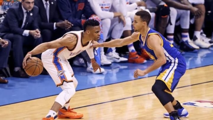 May 24, 2016; Oklahoma City, OK, USA; Oklahoma City Thunder guard Russell Westbrook (0) dribbles as Golden State Warriors guard Stephen Curry (30) defends during the first quarter in game four of the Western conference finals of the NBA Playoffs at Chesapeake Energy Arena. Mandatory Credit: Kevin Jairaj-USA TODAY Sports