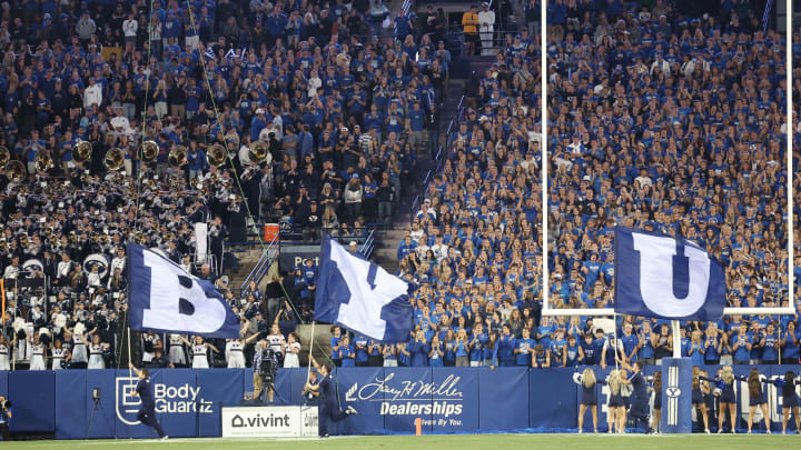 Sep 24, 2022; Provo, Utah, USA; The Brigham Young Cougars cheer squad runs with flags after a touchdown in the third quarter against the Wyoming Cowboys at LaVell Edwards Stadium. Mandatory Credit: Rob Gray-USA TODAY Sports