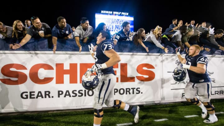 RENO, NV – OCTOBER 08: Offensive lineman Austin Corbett #73 and Nevada teammate offensive lineman Nathan Goltry #62 high five fans after beating Fresno State at Mackay Stadium on October 8, 2016 in Reno, Nevada. (Photo by Jonathan Devich/Getty Images)