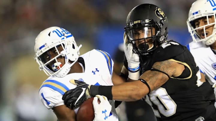PASADENA, CA - SEPTEMBER 30: Drew Lewis #20 of the Colorado Buffaloes tackles Soso Jamabo #1 of the UCLA Bruins during the first half of a game at the Rose Bowl on September 30, 2017 in Pasadena, California. (Photo by Sean M. Haffey/Getty Images)