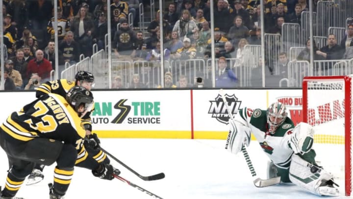 BOSTON, MA - NOVEMBER 23: Minnesota Wild goalie Alex Stalock (32) makes a left pad save on Boston Bruins right defenseman Charlie McAvoy (73) during a game between the Boston Bruins and the Minnesota Wild on November 23, 2019, at TD Garden in Boston, Massachusetts. (Photo by Fred Kfoury III/Icon Sportswire via Getty Images)
