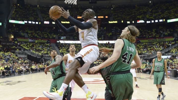 Apr 16, 2016; Atlanta, GA, USA; Atlanta Hawks forward Paul Millsap (4) drives to the basket against Boston Celtics center Kelly Olynyk (41) and forward Amir Johnson (90) during the second half in game one of the first round of the NBA Playoffs at Philips Arena. Mandatory Credit: John David Mercer-USA TODAY Sports