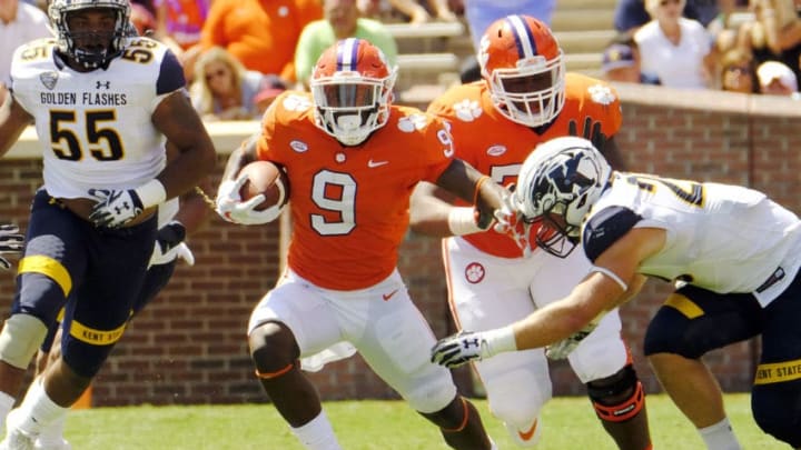 CLEMSON, SC - SEPTEMBER 2: Running back Travis Etienne #9 of the Clemson Tigers tries to brush off a tackle by Matt Bahr #29 of the Kent State Golden Flashes on September 2, 2017 at Memorial Stadium in Clemson, South Carolina. (Photo by Todd Bennett/Getty Images)
