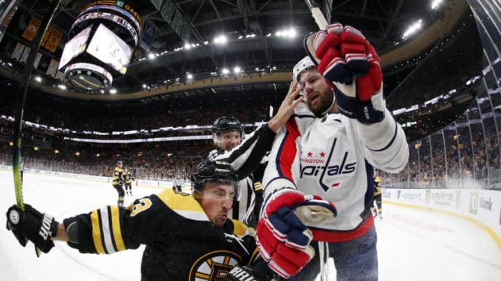BOSTON, MA - NOVEMBER 16: Washington Capitals right wing Tom Wilson (43) hits Boston Bruins left wing Brad Marchand (63) during a game between the Boston Bruins and the Washington Capitals on November 16, 2019, at TD Garden in Boston, Massachusetts. (Photo by Fred Kfoury III/Icon Sportswire via Getty Images)
