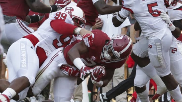 Sep 10, 2016; Tuscaloosa, AL, USA; Alabama Crimson Tide running back B.J. Emmons (21) scores a touchdown as he is grabbed by Western Kentucky Hilltoppers defensive lineman Ty