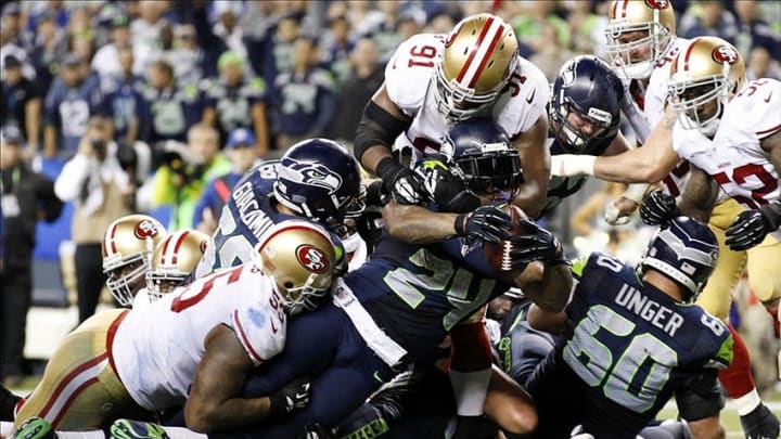 Sep 15, 2013; Seattle, WA, USA; Seattle Seahawks running back Marshawn Lynch (24) rushes for a touchdown against the San Francisco 49ers during the fourth quarter at CenturyLink Field. Mandatory Credit: Joe Nicholson-USA TODAY Sports