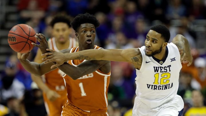 KANSAS CITY, MO – MARCH 09: Andrew Jones #1 of the Texas Longhorns controls the ball as Tarik Phillip #12 of the West Virginia Mountaineers defends during the quarterfinal game of the Big 12 Basketball Tournament at the Sprint Center on March 9, 2017 in Kansas City, Missouri. (Photo by Jamie Squire/Getty Images)