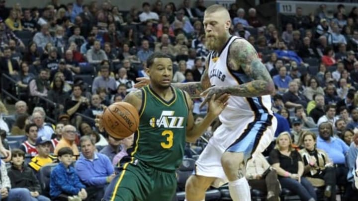 Mar 4, 2016; Memphis, TN, USA; Utah Jazz guard Trey Burke (3) dribbles around Memphis Grizzlies center Chris Andersen (7) in the second quarter at FedExForum. Mandatory Credit: Nelson Chenault-USA TODAY Sports