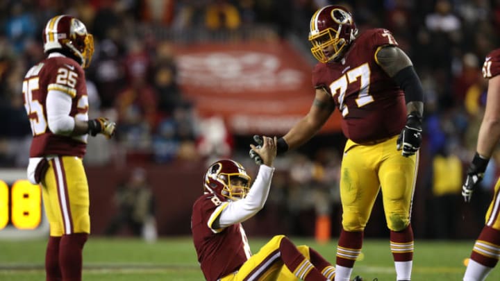 LANDOVER, MD - DECEMBER 19: Guard Shawn Lauvao #77 of the Washington Redskins helps teammate quarterback Kirk Cousins #8 up off of the field in the third quarter against the Carolina Panthers at FedExField on December 19, 2016 in Landover, Maryland. (Photo by Patrick Smith/Getty Images)