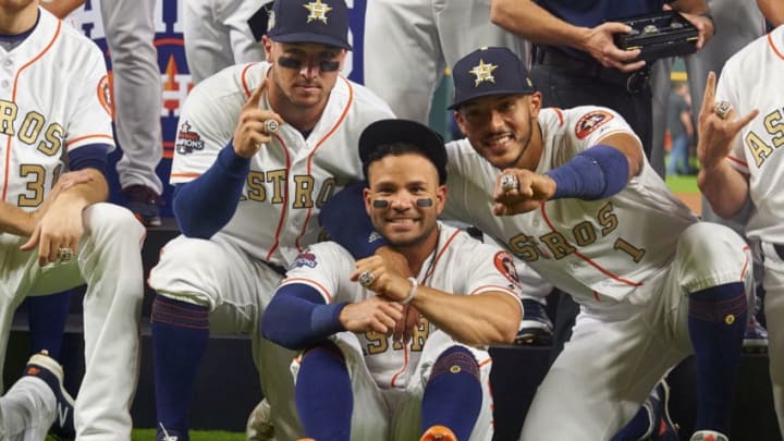 Altuve, Bregman, and Correa of the Houston Astros pose for a photo with their World Series Championship rings before the first pitch against the Baltimore Orioles at Minute Maid Park on Monday, April 3, 2018 in Houston, Texas. (Photo by Cooper Neill/MLB Photos via Getty Images)