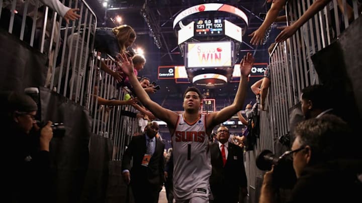 PHOENIX, AZ - OCTOBER 17: Devin Booker #1 of the Phoenix Suns high fives fans as he walks off the court following the NBA game against the Dallas Mavericks at Talking Stick Resort Arena on October 17, 2018 in Phoenix, Arizona. The Suns defeated defeated the Mavericks 121-100. NOTE TO USER: User expressly acknowledges and agrees that, by downloading and or using this photograph, User is consenting to the terms and conditions of the Getty Images License Agreement. (Photo by Christian Petersen/Getty Images)