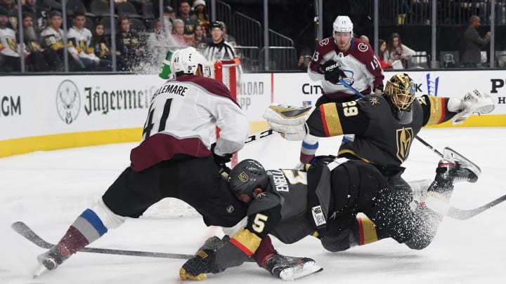 LAS VEGAS, NEVADA – DECEMBER 23: Deryk Engelland #5 of the Vegas Golden Knights crashes into Pierre-Edouard Bellemare #41 of the Colorado Avalanche as Marc-Andre Fleury #29 of the Golden Knights defends the net in the third period of their game at T-Mobile Arena on December 23, 2019 in Las Vegas, Nevada. The Avalanche defeated the Golden Knights 7-3. (Photo by Ethan Miller/Getty Images)