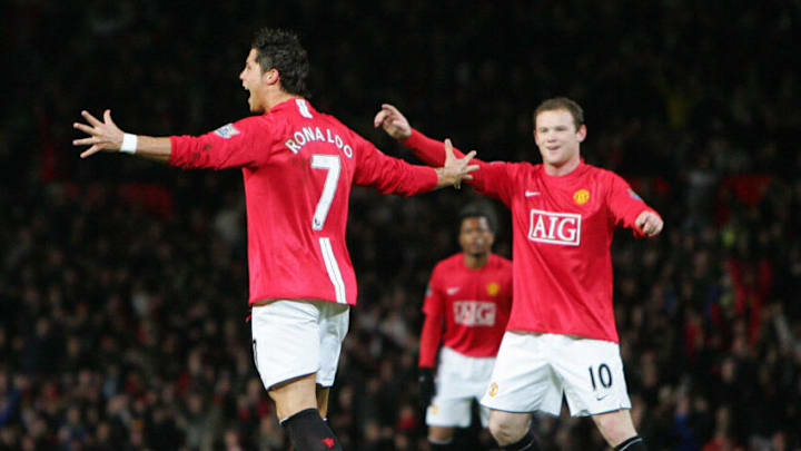 Manchester United's Portuguese midfielder Cristiano Ronaldo (L) celebrates with English forward Wayne Rooney after scoring his second goal against Portsmouth during their English Premiership football match at Old Trafford in Manchester, north-west England, 30 January 2008. AFP PHOTO/PAUL ELLIS - Mobile and website use of domestic English football pictures are subject to obtaining a Photographic End User Licence from Football DataCo Ltd Tel : +44 (0) 207 864 9121 or e-mail accreditations@football-dataco.com - applies to Premier and Football League matches. (Photo credit should read PAUL ELLIS/AFP via Getty Images)