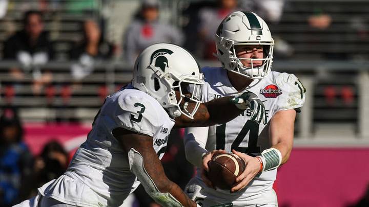 SANTA CLARA, CA - DECEMBER 31: Michigan State Quarterback Brian Lewerke (14) hands off to Michigan State Running Back LJ Scott (3) during the Redbox Bowl between the Michigan State Spartans and the Oregon Ducks at Levi's Stadium on December 31, 2018 in Santa Clara, CA. (Photo by Cody Glenn/Icon Sportswire via Getty Images)