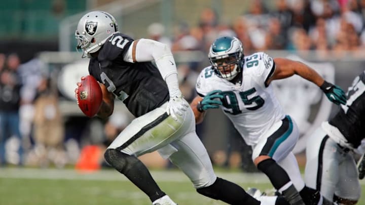 OAKLAND, CA - NOVEMBER 03: Quarterback Terrelle Pryor #2 of the Oakland Raiders scrambles under pressure from Mychal Kendricks #95 of the Philadelphia Eagles in the second quarter on November 3, 2013 at O.co Coliseum in Oakland, California. The Eagles won 49-20. (Photo by Brian Bahr/Getty Images)