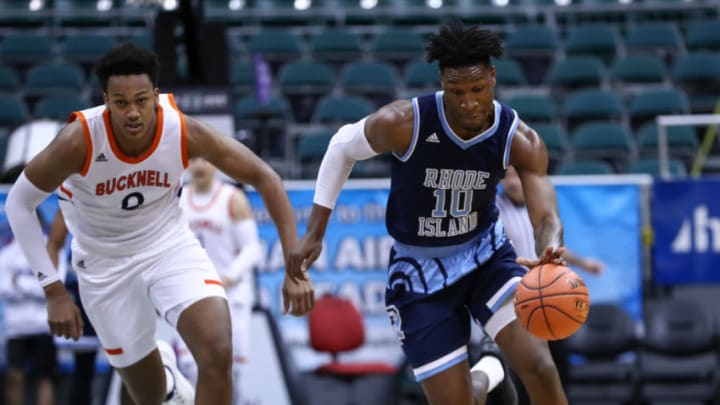HONOLULU, HI - DECEMBER 22: Cyril Langevine #10 of the Rhode Island Rams pushes the ball up court Paul Newman #0 of the Bucknell Bison tries to chase him down during the first half of their game at Stan Sheriff Center on December 22, 2018 in Honolulu, Hawaii. (Photo by Darryl Oumi/Getty Images)
