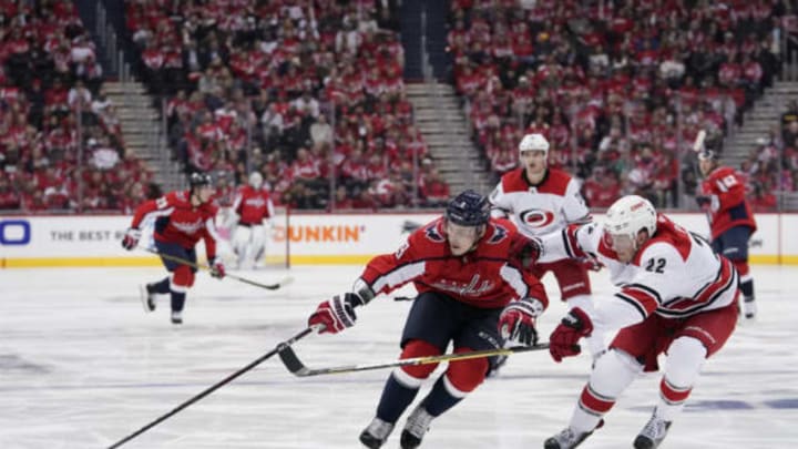 WASHINGTON, DC – APRIL 11: Dmitry Orlov #9 of the Washington Capitals skates with the puck against Brett Pesce #22 of the Carolina Hurricanes in the third period in Game One of the Eastern Conference First Round during the 2019 NHL Stanley Cup Playoffs at Capital One Arena on April 11, 2019 in Washington, DC. (Photo by Patrick McDermott/NHLI via Getty Images)