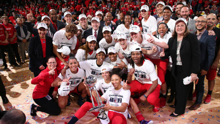 WASHINGTON, DC –  OCTOBER 10: The the Washington Mystics pose for a photo with the WNBA Championship Trophy afterGame Five of the 2019 WNBA Finals on October 10, 2019 at St Elizabeths East Entertainment & Sports Arena in Washington, DC. NOTE TO USER: User expressly acknowledges and agrees that, by downloading and or using this Photograph, user is consenting to the terms and conditions of the Getty Images License Agreement. Mandatory Copyright Notice: Copyright 2019 NBAE (Photo by Ned Dishman/NBAE via Getty Images)