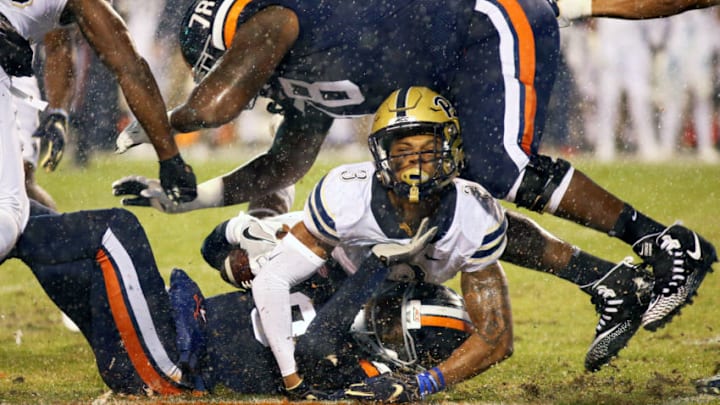 CHARLOTTESVILLE, VA - NOVEMBER 02: Damar Hamlin #3 of the Pittsburgh Panthers tackles Bryce Perkins #3 of the Virginia Cavaliers underneath R.J. Proctor #78 in the first half during a game at Scott Stadium on November 2, 2018 in Charlottesville, Virginia. (Photo by Ryan M. Kelly/Getty Images)