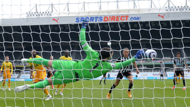 NEWCASTLE UPON TYNE, ENGLAND - APRIL 04: Hugo Lloris of Tottenham Hotspur makes a save from Dwight Gayle of Newcastle United during the Premier League match between Newcastle United and Tottenham Hotspur at St. James Park on April 04, 2021 in Newcastle upon Tyne, England. . (Photo by Peter Powell - Pool/Getty Images)