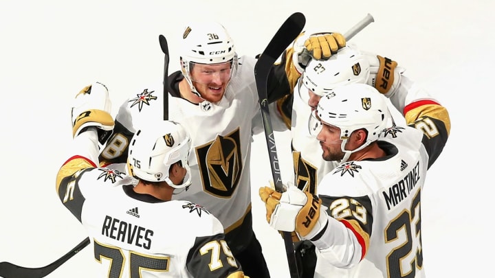 Shea Theodore #27 of the Vegas Golden Knights (2nd from right) celebrates his goal at 13:58 of the first period against the Chicago Blackhawks