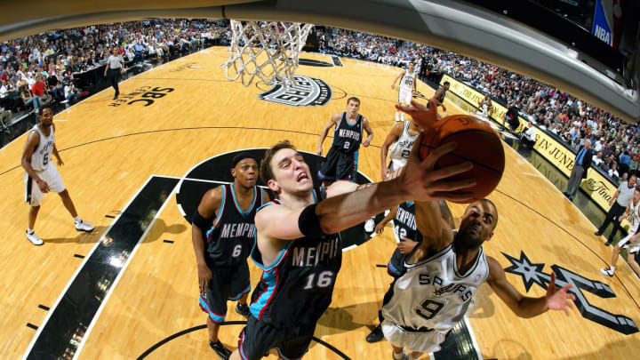 SAN ANTONIO – APRIL 19: Forward Pau Gasol #16 of the Memphis Grizzlies battles for a rebound with Tony Parker #9 of the San Antonio Spurs in game two of the first round of the NBA Western Conference Playoffs on April 19, 2004 at the SBC Center in San Antonio, Texas. NOTE TO USER: User expressly acknowledges and agrees that, by downloading and/or using this Photograph, User is consenting to the terms and conditions of the Getty Images License Agreement. (Photo by Ronald Martinez/Getty Images)