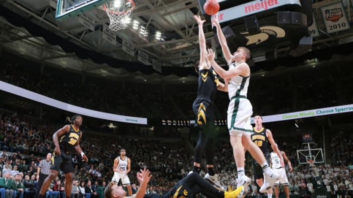 EAST LANSING, MI - DECEMBER 03: Thomas Kithier #15 of the Michigan State Spartans shoots the ball over Ryan Kriener #15 of the Iowa Hawkeyes in the first half at Breslin Center on December 3, 2018 in East Lansing, Michigan. (Photo by Rey Del Rio/Getty Images)