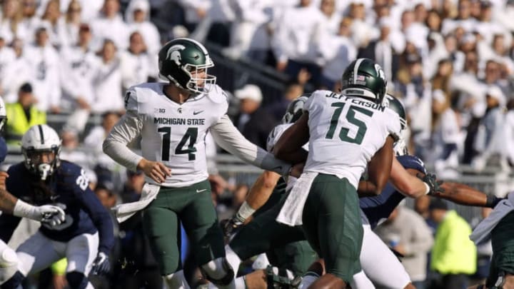 STATE COLLEGE, PA - OCTOBER 13: Brian Lewerke #14 of the Michigan State Spartans hands off to La'Darius Jefferson #15 of the Michigan State Spartans against the Penn State Nittany Lions on October 13, 2018 at Beaver Stadium in State College, Pennsylvania. (Photo by Justin K. Aller/Getty Images)