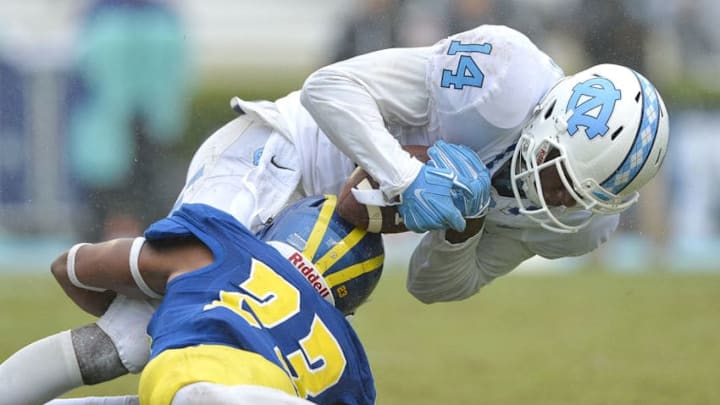 CHAPEL HILL, NC - SEPTEMBER 26: Nasir Adderley #23 of the Delaware Fightin Blue Hens tackles Quinshad Davis #14 of the North Carolina Tar Heels during their game at Kenan Stadium on September 26, 2015 in Chapel Hill, North Carolina. North Carolina won 41-14. (Photo by Grant Halverson/Getty Images) CHAPEL HILL, NC - SEPTEMBER 26: Nasir Adderley #23 of the Delaware Fightin Blue Hens tackles Quinshad Davis #14 of the North Carolina Tar Heels during their game at Kenan Stadium on September 26, 2015 in Chapel Hill, North Carolina. North Carolina won 41-14. (Photo by Grant Halverson/Getty Images)