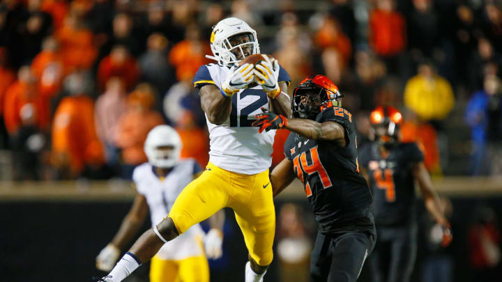 STILLWATER, OK – NOVEMBER 17: Wide receiver Gary Jennings Jr. #12 of the West Virginia Mountaineers makes a catch over safety Jarrick Bernard #24 of the Oklahoma State Cowboys in the fourth quarter on November 17, 2018 at Boone Pickens Stadium in Stillwater, Oklahoma. Oklahoma State upset West Virginia 45-41. (Photo by Brian Bahr/Getty Images)